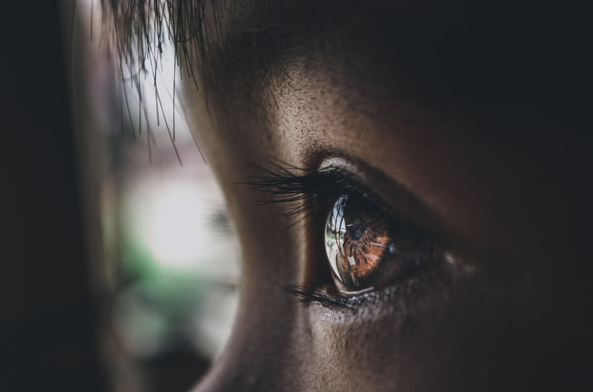 persons eye in close up photography