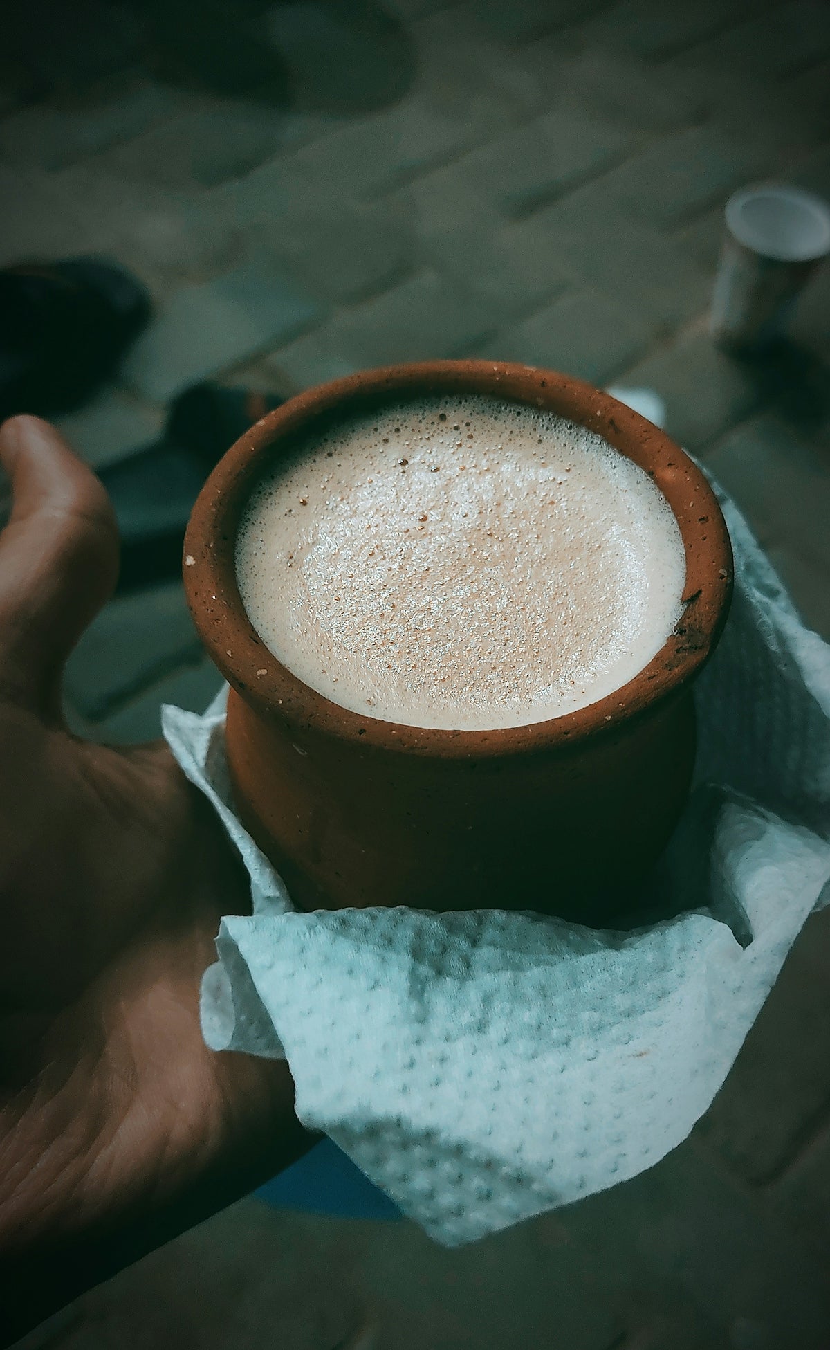 a hand holding a cup of coffee