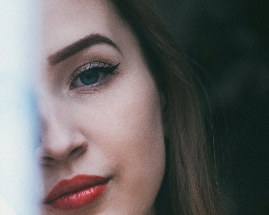 woman with red lipstick and black mascara