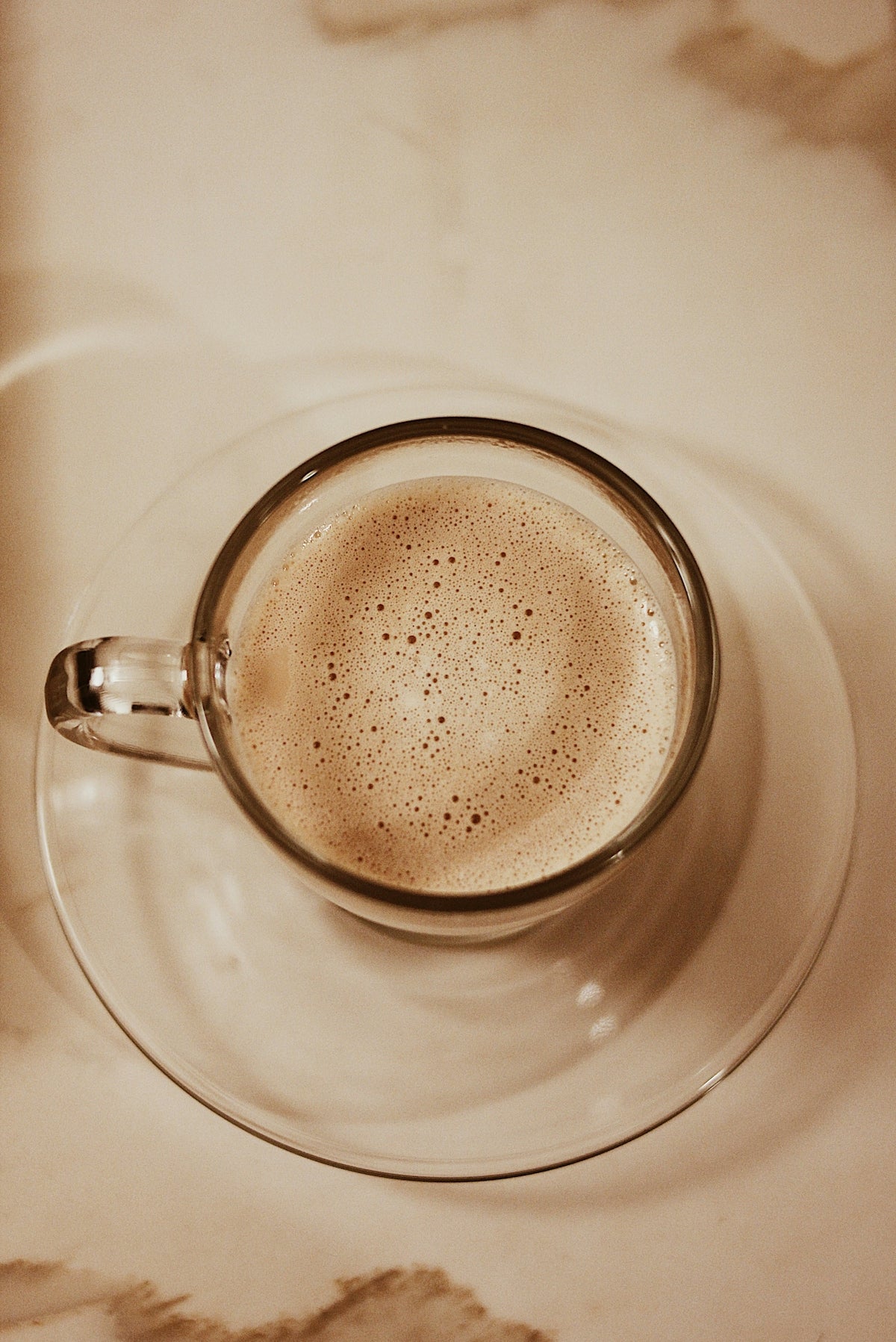 clear glass cup with brown liquid