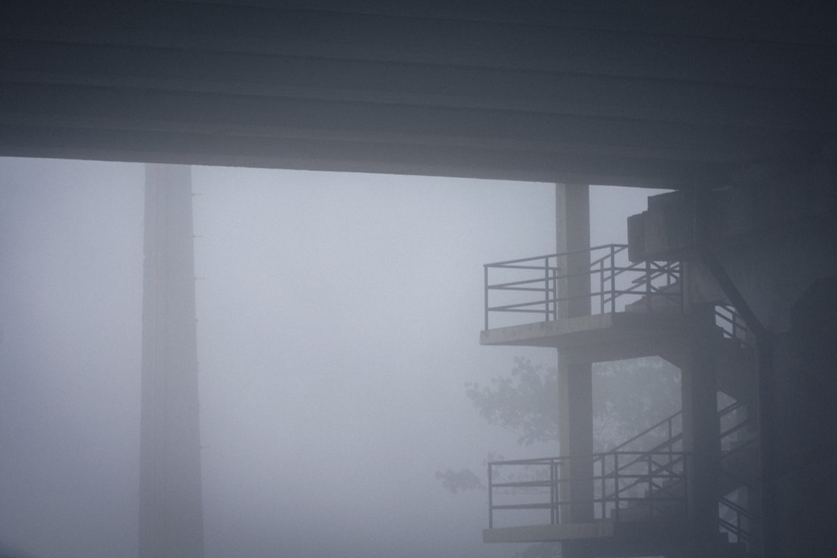 a building with a fire escape in the fog