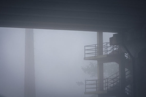 a building with a fire escape in the fog