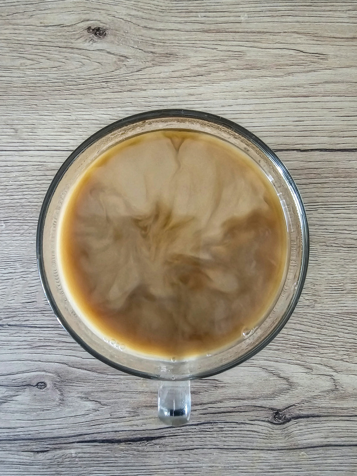 A cup of coffee sitting on top of a wooden table